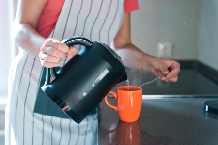 pouring hot drink to the mug の写真素材