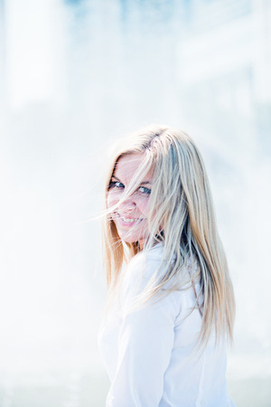 Beautiful young blond woman outdoors portrait の写真素材