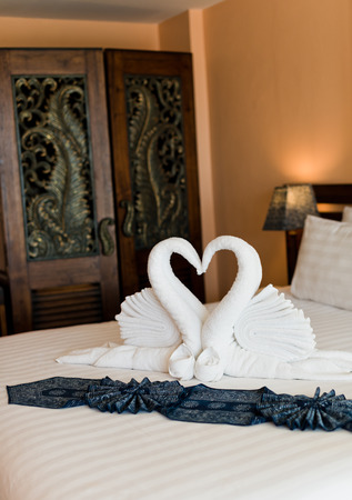 swans made from towels on the hotel bed. のeditorial素材