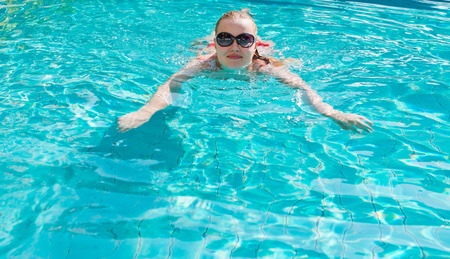 Young woman in the swimming pool 