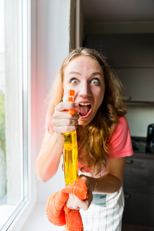 crazy woman housewife washes a window の写真素材
