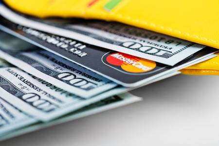 YEKATAERINBURG, RUSSIA - APR 25, 2014: US dollars bills and Mastercard credit card in wallet. 