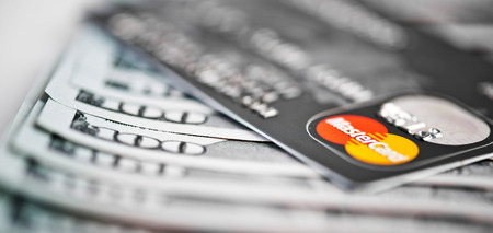 YEKATAERINBURG, RUSSIA - APR 25, 2014: Mastercard Debit Card Over Dollar bills 
