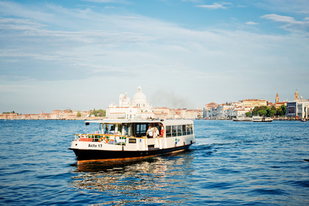 VENICE, ITALY - JULY 12, 2014: Ship carrying people in the waters of Grand Canal.Venice is one of the most popular tourist destinations in the world      のeditorial素材