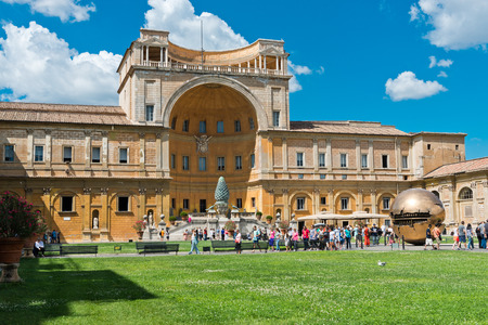 VATICAN CITY, VATICAN - JULY 15 2014: People around Sphere within sphere in Courtyard of the Pinecone at Vatican Museums. Sphere was created in 1990 by Italian sculptor Arnoldo Pomodoro. のeditorial素材