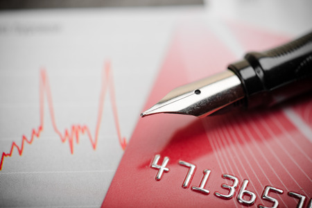 Credit card,  fountain pen and diagram.の写真素材