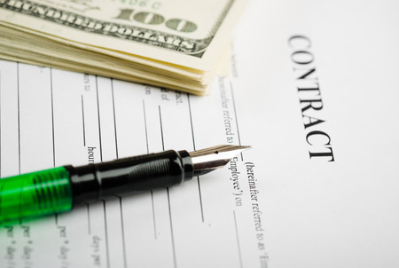 Pen on the contract papers and us dollarsの写真素材