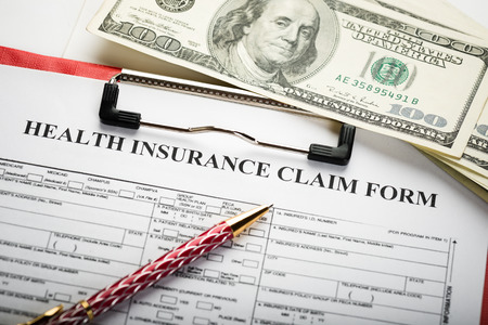 Health insurance application form with banknote and stethoscope concept for life planningの写真素材