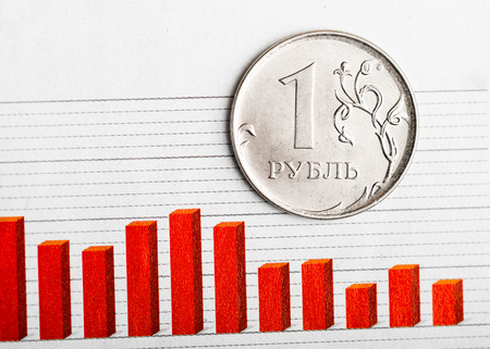 One rouble coin on fluctuating graph. Rate of the Russian rouble (shallow DOF)の写真素材