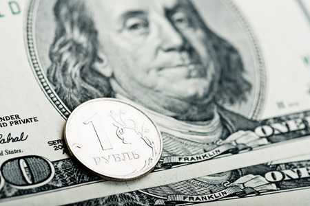 russian roubles coins on banknotes of dollars andの写真素材