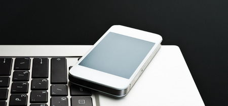 keyboard with phone on black background