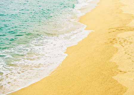 Wave of the sea on the sand beachの写真素材