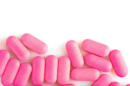 Group of pink medical pills isolated on white backgroundの写真素材