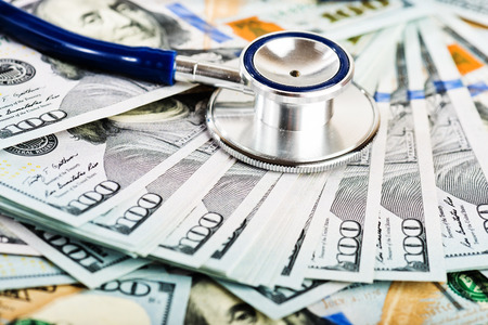 A medical stethoscope on dollars