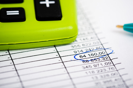 Pen and Calculator on a paper with graph and charts. Green Theme color.