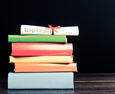 Stack Of Text Books And Graduation Scrollの写真素材