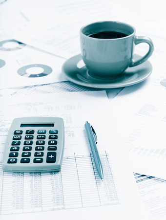 Business report. Cup of coffee on document. Accounting.  Blue tonedの写真素材