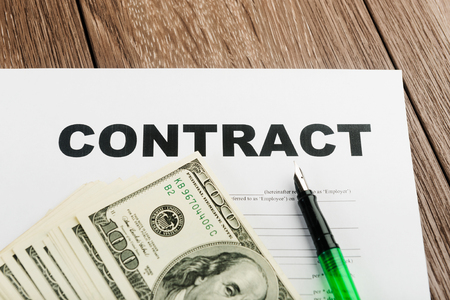 Pen and contract papers on wooden deskの写真素材
