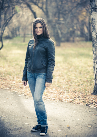 young woman portrait in autumn parkの写真素材