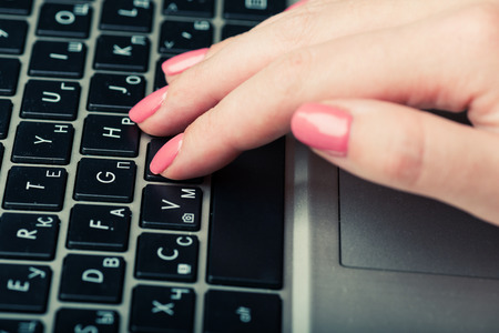 Human hands working on laptopの写真素材