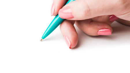 Close up of women hand writing with metallic pen. Isolated on white background.の写真素材