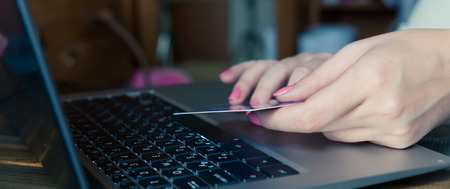 Woman shopping online with credit card and computerの写真素材