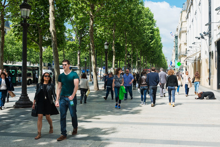 PARIS, MAY 22 2015: tourisrs on the Avenue des Champs-elysees. Avenue des Champs Elysees is the biggest and most famous and expensive boulevard in the worldのeditorial素材