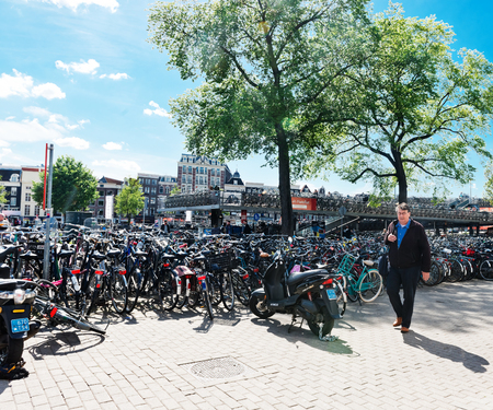 AMSTERDAM, NETHERLANDS - JUNE 01, 2015: Huge bicycle parking in front of the central station Amsterdam.  Amsterdam is the capital city and most populous city of the Kingdom of the Netherlands.のeditorial素材