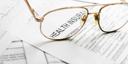 Health insurance claim form with glassesの写真素材