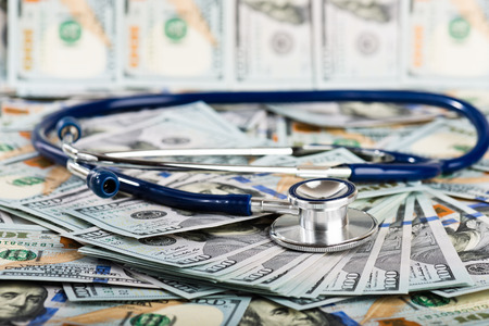 A medical stethoscope on dollarsの写真素材