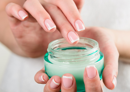 beautiful woman hands with creamの写真素材