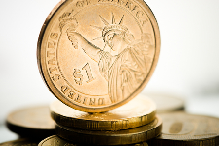 One dollar coin and gold moneyの写真素材