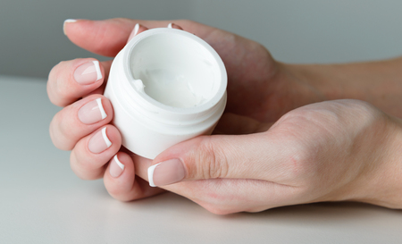 beautiful woman hands with creamの写真素材