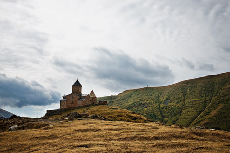 Gergeti christian church near Kazbegi, Stepancminda village in Georgia, Caucasus.の写真素材