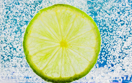 lime with bubbles isolated on whiteの写真素材