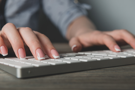 Female office worker typing on the keyboard の写真素材