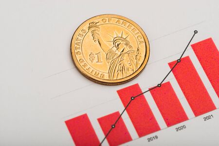ne dollar coin on fluctuating graph. Rate of the us dollar (shallow DOF)