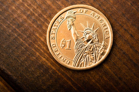 One dollar coin on deskの写真素材