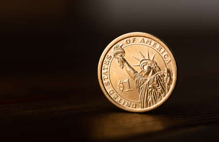 One dollar coin on deskの写真素材
