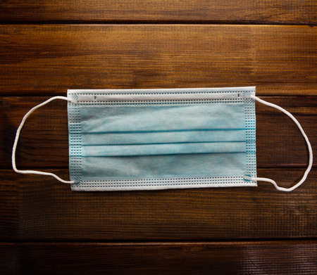 Protective face mask on wood tableの写真素材