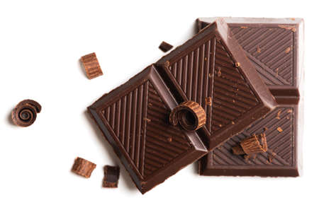 Curls and pieces of tasty chocolate on white table