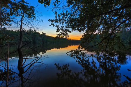 Natural sunset on the lake in Russia. Surprisingly colorful evening sky, background from Russia.の写真素材