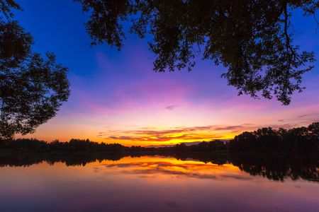 Natural sunset on the lake in Russia. Surprisingly colorful evening sky, background from Russia.の写真素材