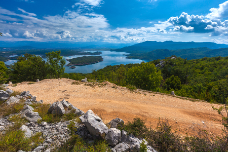 Slansko lake, Niksic, at the foot of Mount Trebjesa, Montenegro. Island on a sunny sky with beautiful clouds.の写真素材