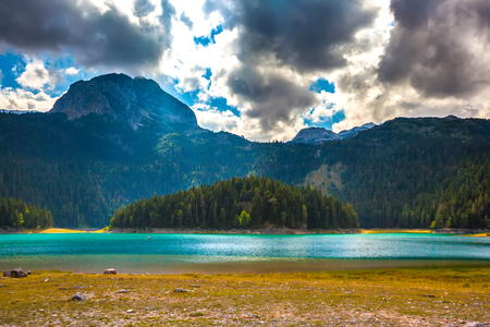 Azure lake on the background of mountains Bobotov Kuk. Black Lake. Durmitor National Park. Montenegro.の写真素材