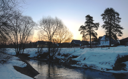 Winter scene with flowing river.の写真素材