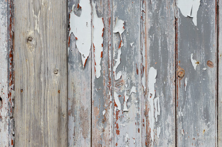 Background of wooden boards with weathered cracked gray paintの写真素材
