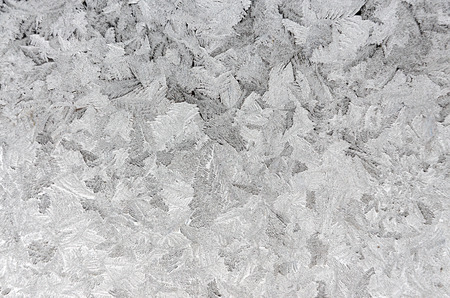 Icy frosty pattern on a window.Christmas background.Rime texture.Abstraction.の写真素材