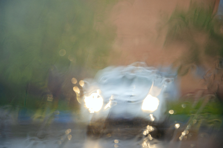 Adverse driving conditions. Heavy rain. View through car windshield.の写真素材