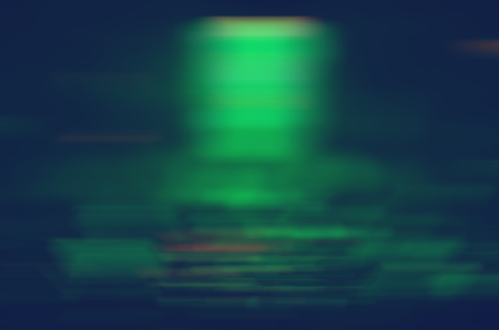 Abstract blurred green lights on a dark background
